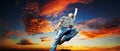 Man jumping out of happiness and emotions in front of a dramatic cloudy sunset Royalty Free Stock Photo