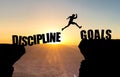 Man jumping over abyss with text DISCIPLINE/GOALS. Royalty Free Stock Photo