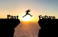 Man jumping over abyss with text Past/Future. Royalty Free Stock Photo