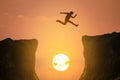 Man jumping over the cliff, silhouette Royalty Free Stock Photo