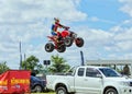 Man jumping over vehicles on a quad bike. Royalty Free Stock Photo