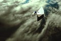 man jumping from a paper boat into the cloudy sky. Young male jumping off a boat, enjoying the freedom. Mixed media