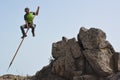 A man jumping from a rock