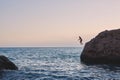 Man jumping into the sea from the cliff Royalty Free Stock Photo