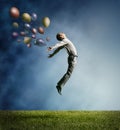 Man jumping up to Sky wit color bright balloon Royalty Free Stock Photo