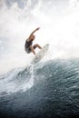 Man jumping on the white wakeboard down the blue water against g Royalty Free Stock Photo