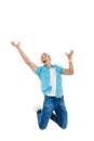 man jumps in the air with his hands up as if he trying to catches money Royalty Free Stock Photo