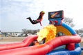 Man Jumps Over Fireball To Dunk Ball In Carnival Act