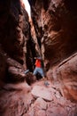 A man jumps from stone in Jenny`s canyon within Snow canyon