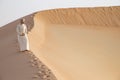 Man in kandura in a desert at sunrise Royalty Free Stock Photo