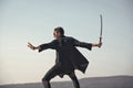 Man with katana sword standing on blue sky Royalty Free Stock Photo