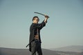 Man with katana sword standing on blue sky Royalty Free Stock Photo