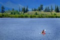 Man on Kayak on Lake Mountains Wilderness Paddling