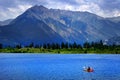 Man on Kayak on Lake Mountains Wilderness Paddling