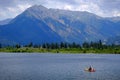 Man on Kayak on Lake Mountains Wilderness Paddling