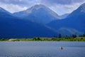 Man on Kayak on Lake Mountains Wilderness Paddling