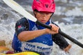 Man in a kayak with paddle in white water