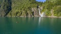 Man in kayak paddling towards the waterfall