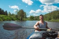 Man in kayak trip rowing boat on the river, a water hike, a summer adventure. Eco-friendly and extreme tourism, active and healthy Royalty Free Stock Photo