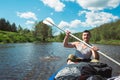 Man in kayak trip rowing boat on the river, a water hike, a summer adventure. Eco-friendly and extreme tourism, active and healthy Royalty Free Stock Photo