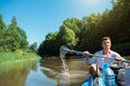 Man in kayak trip rowing boat on the river, a water hike, a summer adventure. Eco-friendly and extreme tourism, active and healthy Royalty Free Stock Photo