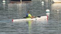 Man kayaking around moored boats