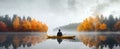 a man kayaking in an autumn colored lake Royalty Free Stock Photo