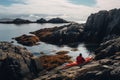 Man kayaking on a rocky sea shore in the evening light, Red kayak and man camping on coastal rocks, AI Generated