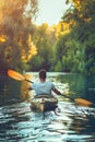 Man kayaking at sunset, paddling canoe on sea, enjoying outdoor adventure and scenic beauty Royalty Free Stock Photo