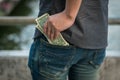 Man keep Us dollars money in jeans pocket Royalty Free Stock Photo