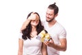 Man keeps his girlfriend eyes covered while she giving a gift