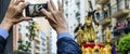 A man keeps on his mobile phone the image of the step of the Procession of Jesus the Nazarene in Huelva, Spain