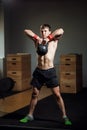 Man with kettleball on hand, dark background