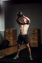 Intensive cross training. man in sportswear working out with kettle bell at gym