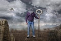 Man with keyhole instead of a head holds large key Royalty Free Stock Photo