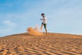 A man is kicking sand in a red desert. Splash of anger concept Royalty Free Stock Photo
