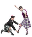 Man in kilt teaching woman Scottish dance