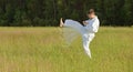 Man in kimono fulfills blows by feet in field