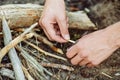 Man kindles a fire in summer wood