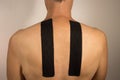 Man with Kinesio Tape on his back for pain Royalty Free Stock Photo