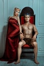 Man king sitting on the throne beside Queen woman. Royalty Free Stock Photo