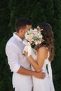 Man kiss woman and hide by bouquet. Wedding day