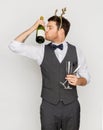 Man kissing bottle of champagne at christmas party Royalty Free Stock Photo