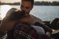 Man kissing and hugging his girlfriend by the river Royalty Free Stock Photo