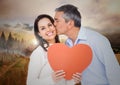 Man kissing woman holding a heart Royalty Free Stock Photo