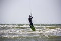 Man Kiteboarding and Jumping on a Kite Board