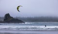 Man Kitesurfing in the Pacific Ocean on the waves.