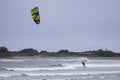 Man Kitesurfing in the Pacific Ocean on the waves.