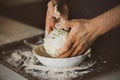 A man kneads dough in a plate with his hands. Home cooking. The process of making dough for homemade bread. Bakery products Royalty Free Stock Photo