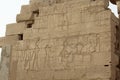 Man kneeling in front of the Theban triad in the mortuary temple of Ramesseum in Luxor